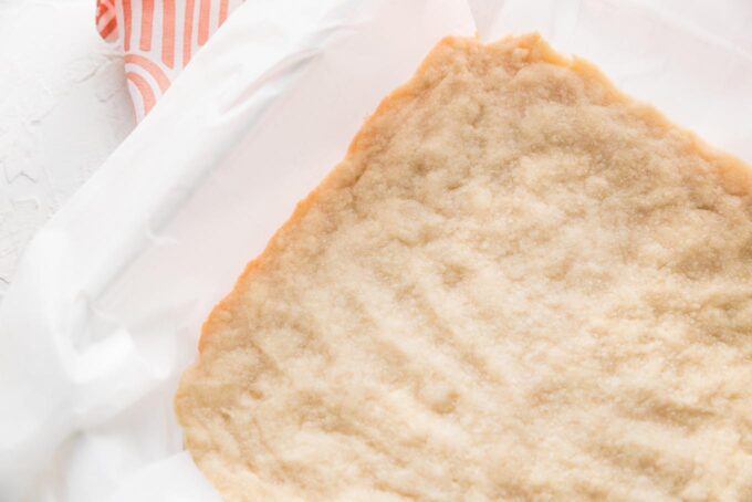 Close up image of shortbread crust, baked just enough for the very edge to be very lightly golden.