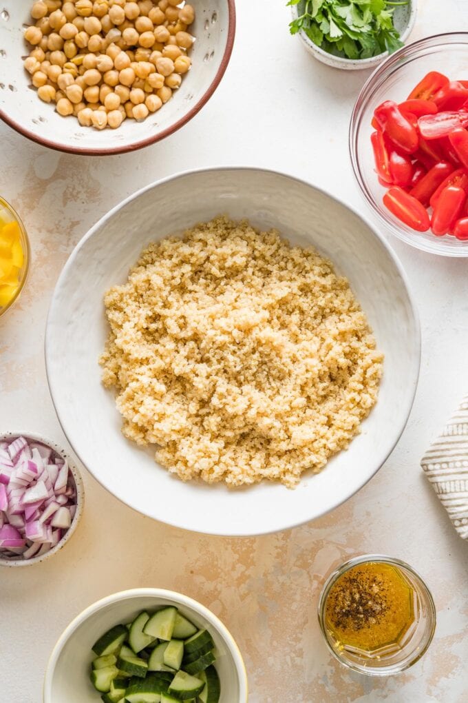 Serving bowl full of cooked quinoa, cooling to room temperature.