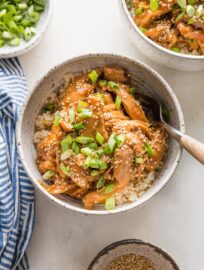 Two bowls of slow cooker teriyaki chicken ready to eat with forks.