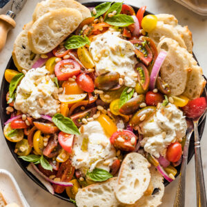Plate of marinated tomatoes and burrata.