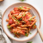 Small wooden bowl filled with a serving of homemade pasta marinara.