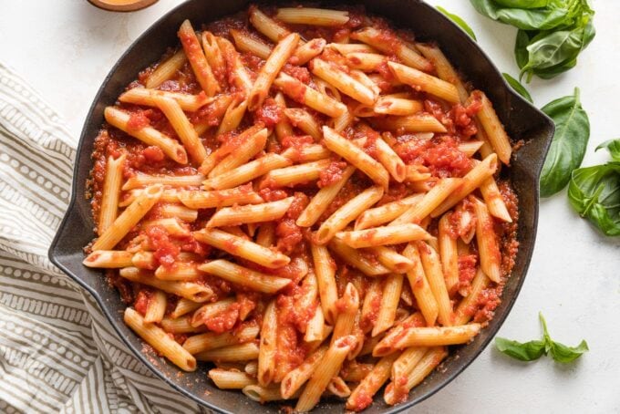 Homemade pasta marinara finished in a cast iron skillet.