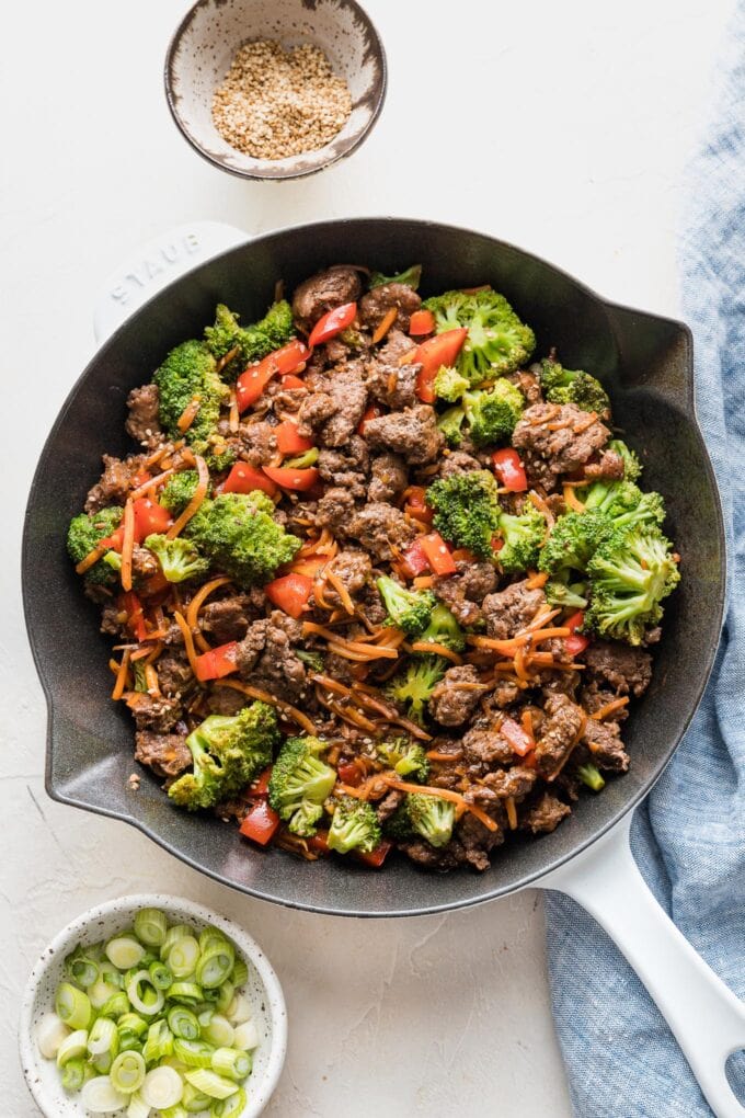 Skillet full of teriyaki ground beef with broccoli, bell pepper, and carrots.