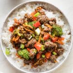 Bowl of teriyaki ground beef with vegetables served over white rice.