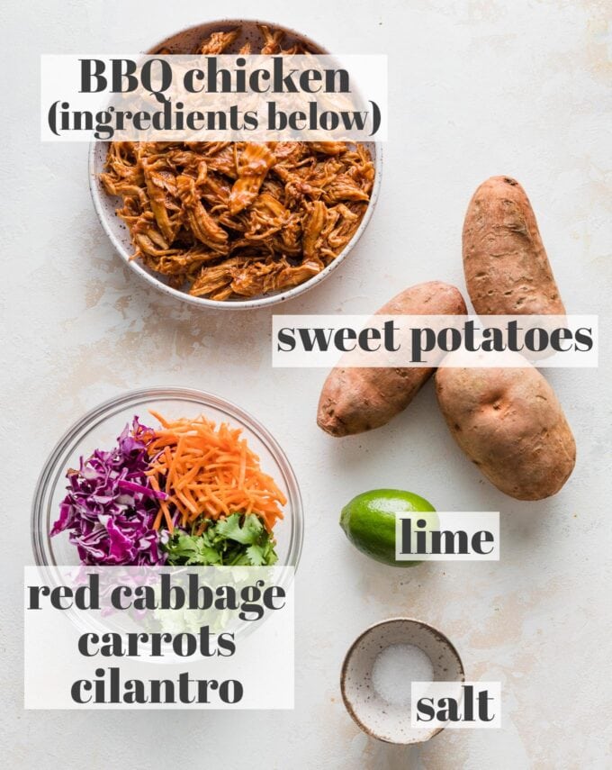 Labeled overhead image of pulled BBQ chicken, sweet potatoes, red cabbage, shredded carrots, cilantro, limes, and salt in prep bowls.
