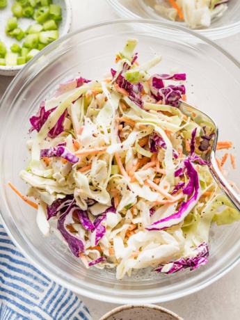 Clear serving bowl full of a healthy homemade coleslaw ready to eat.