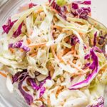 Add this healthy homemade coleslaw to your menu for tastier sandwiches, potlucks, and picnics galore. It's crunchy, fresh, and vibrant, with colorful cabbage, carrots, and a sweet and tangy dressing. Easy to make to your taste from scratch and way better than anything store-bought!