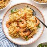 Small pasta bowl filled with a serving of jerk shrimp pasta garnished with parsley and ready to eat.