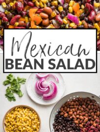 A large Mexican three bean salad with homemade cilantro vinaigrette, in a white bowl ready to serve.