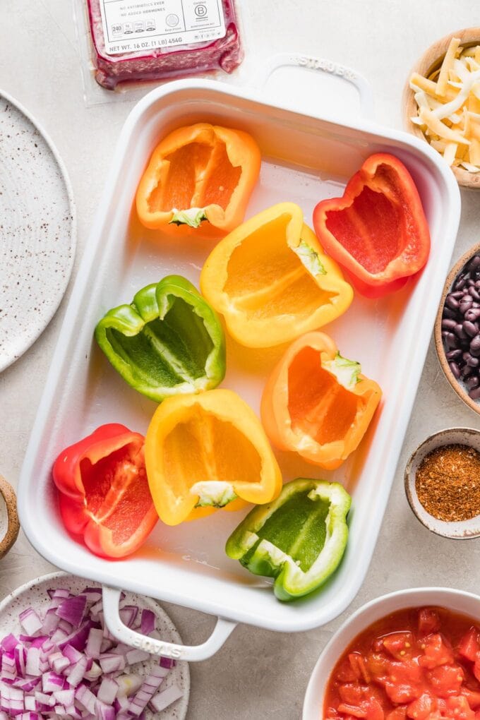 Cut open bell peppers in a casserole dish.