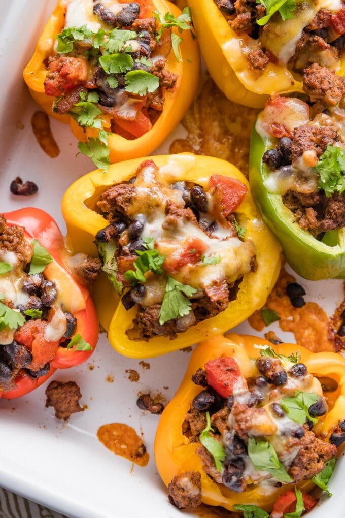 Close up of a yellow bell pepper cut open and stuffed with a ground beef taco mixture.