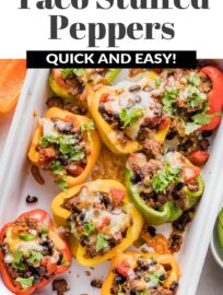 Taco Stuffed Peppers are an easy dinner that will satisfy the whole family! Tender and vibrant bell peppers are stuffed with a generously seasoned mix of ground meat, black beans, and tomatoes. Top with cheese for a filling and fun weeknight dinner.