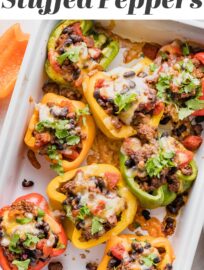Taco Stuffed Peppers are an easy dinner that will satisfy the whole family! Tender and vibrant bell peppers are stuffed with a generously seasoned mix of ground meat, black beans, and tomatoes. Top with cheese for a filling and fun weeknight dinner.