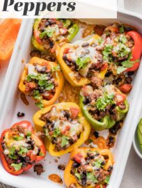 Taco Stuffed Peppers are an easy dinner that will satisfy the whole family! Tender and vibrant bell peppers are stuffed with a generously seasoned mix of ground meat, black beans, and tomatoes. Top with cheese for a filling and fun weeknight dinner.