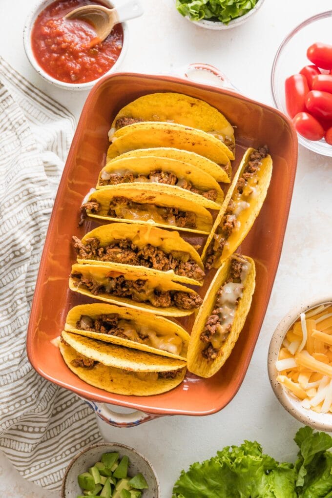 Dish of baked tacos, fresh out of the oven and ready to be topped.