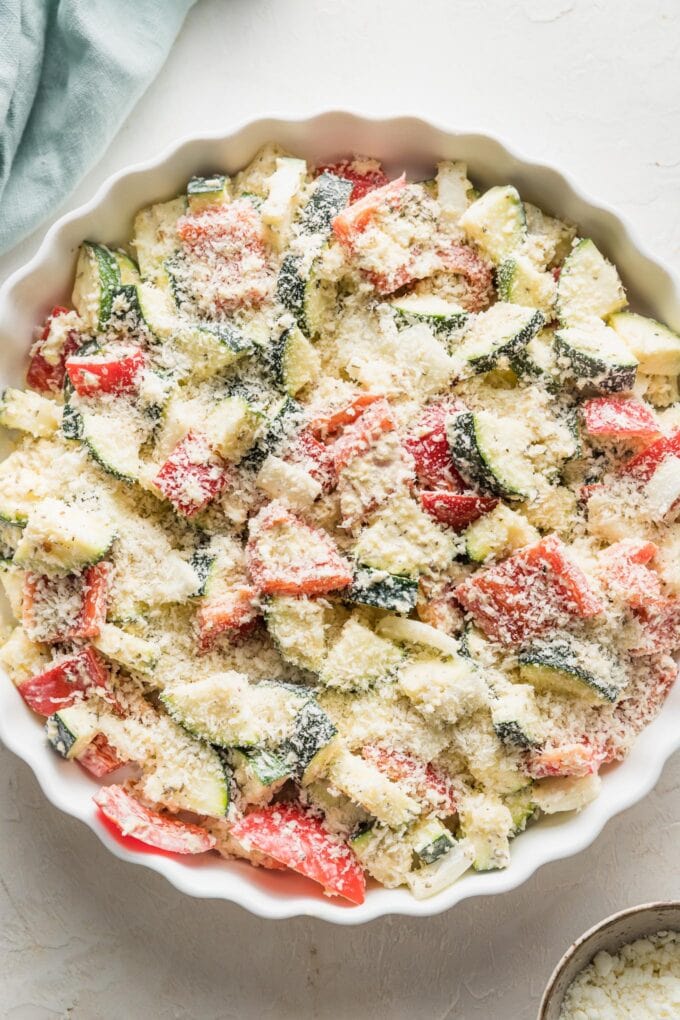 An unbaked zucchini casserole dusted with Panko breadcrumbs and ready to go into the oven.