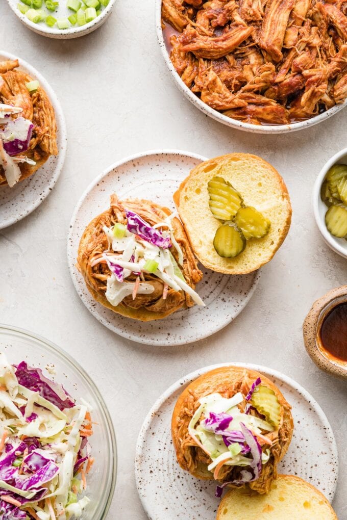 Overhead image of a BBQ chicken sandwich on a brioche bun with coleslaw.