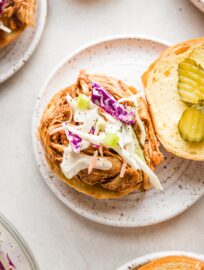 Overhead image of a BBQ chicken sandwich on a brioche bun with coleslaw.