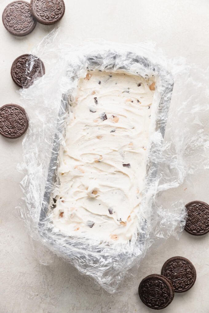 Loaf pan with an ice cream cake inside.