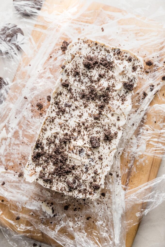 Oreo crumbs sprinkled on top of a loaf pan ice cream cake.