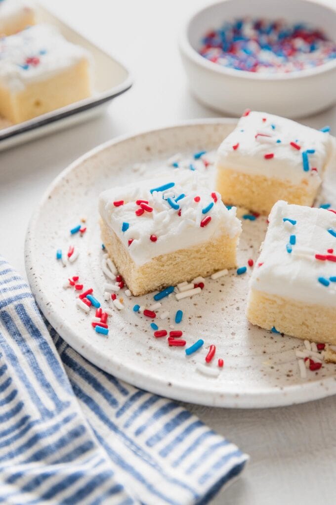Angled view of a soft sugar cookie bar decorated with patriotic red, white, and blue sprinkles.