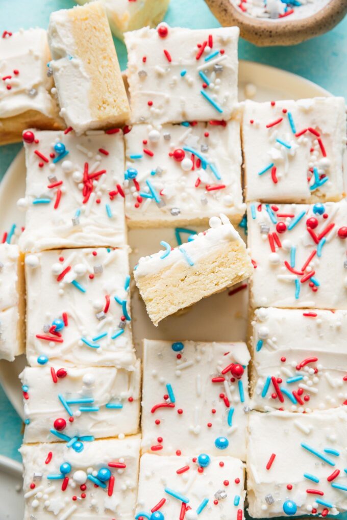 Platter filled with frosted sugar cookie bars topped with red, white, and blue sprinkles