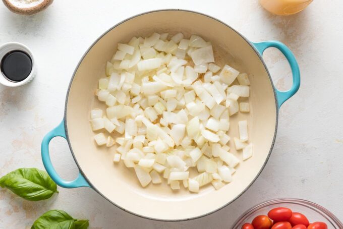 Onions and garlic softened in an enameled cast iron skillet.