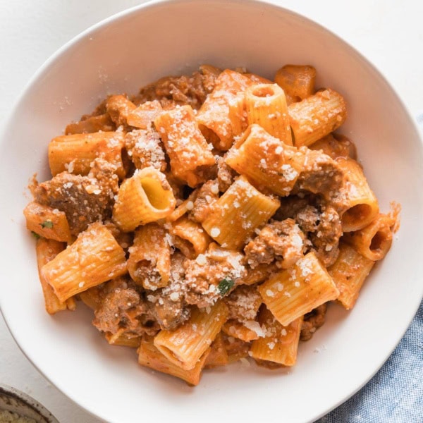 Small pasta bowl filled with a serving of ground beef pasta.