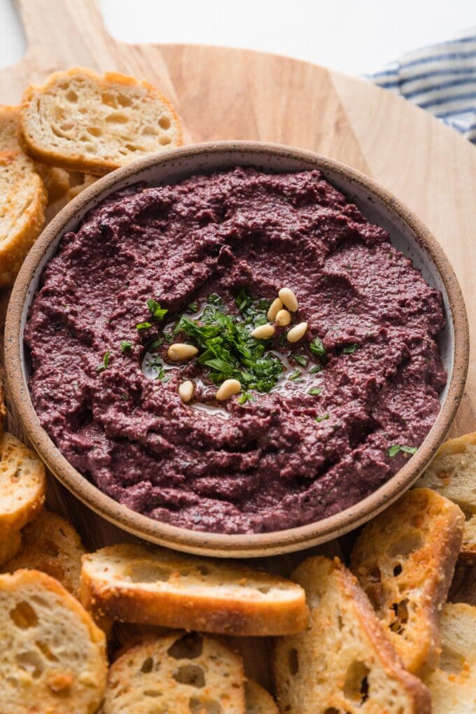 Close up of olive tapenade in a small serving bowl.
