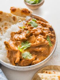 This easy Slow Cooker Butter Chicken recipe delivers a delicious dinner with simple prep and minimal dishes! Tender chicken thighs simmer all day in a savory, creamy, rich sauce. Serve with rice, naan, and your favorite veggies for a fun but fuss-free meal.