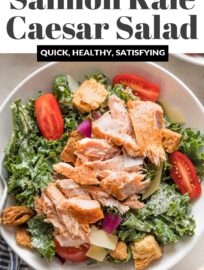 This Salmon Kale Caesar Salad is packed with tangy Parmesan, juicy tomatoes, tart red onions, crunchy croutons, and tender baked salmon for a delicious twist on a classic. We love this for a flavorful, feel-good lunch or light dinner.