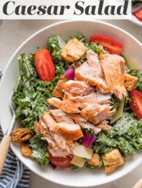 This Salmon Kale Caesar Salad is packed with tangy Parmesan, juicy tomatoes, tart red onions, crunchy croutons, and tender baked salmon for a delicious twist on a classic. We love this for a flavorful, feel-good lunch or light dinner.