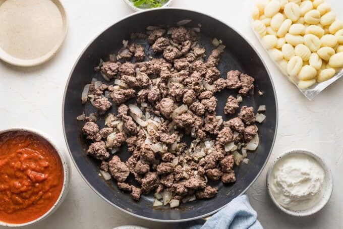 Ground beef and chopped onion browned together in a large skillet.