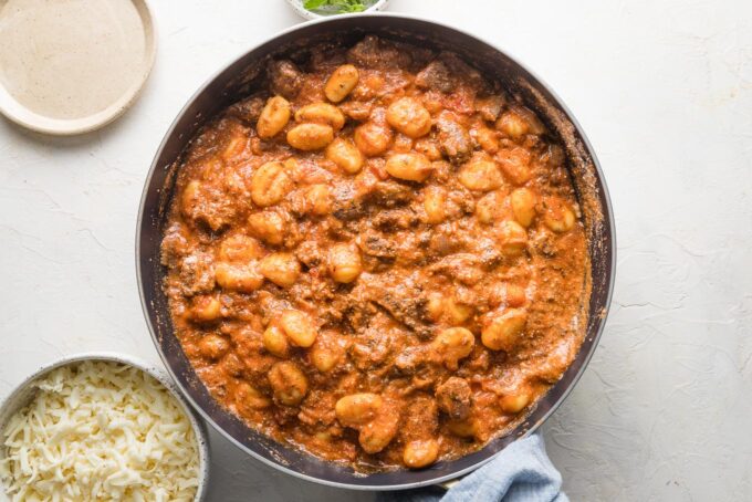 Gnocchi stirred into sauce to coat evenly.