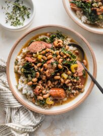 Shallow bowl filled with rice and a stew-like black eyed peas recipe.