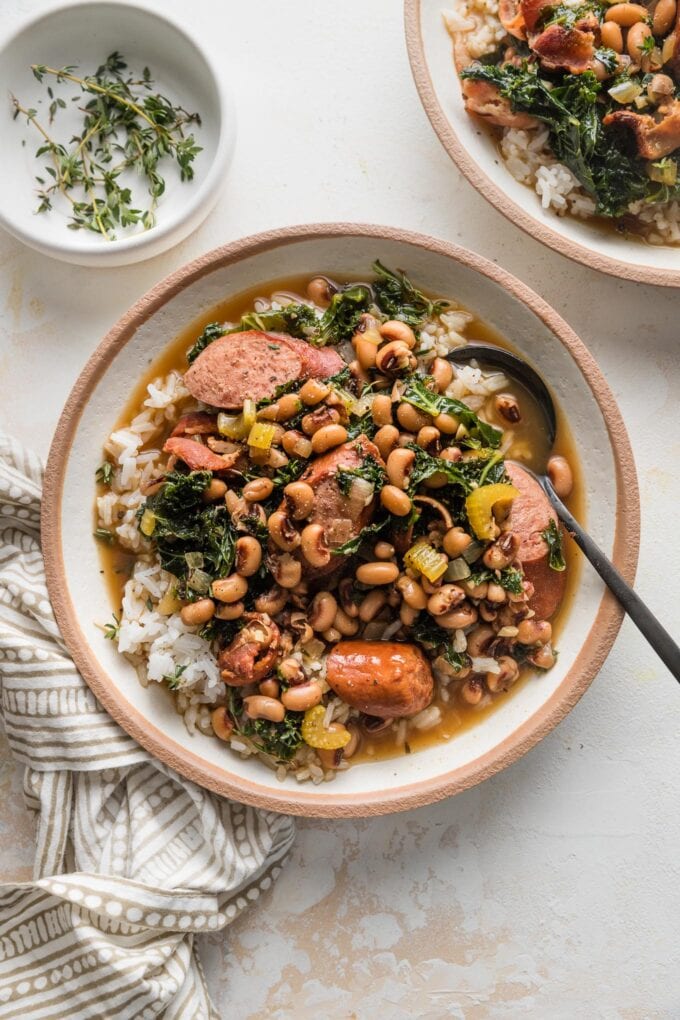 Shallow bowl filled with rice and a stew-like black eyed peas recipe.