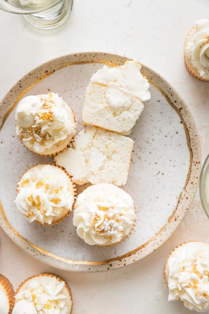 Plate of filled champagne cupcakes.