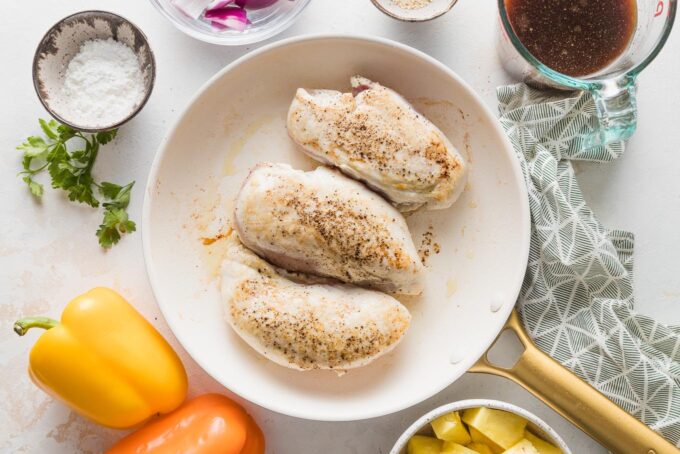 Seared chicken breasts in a skillet.