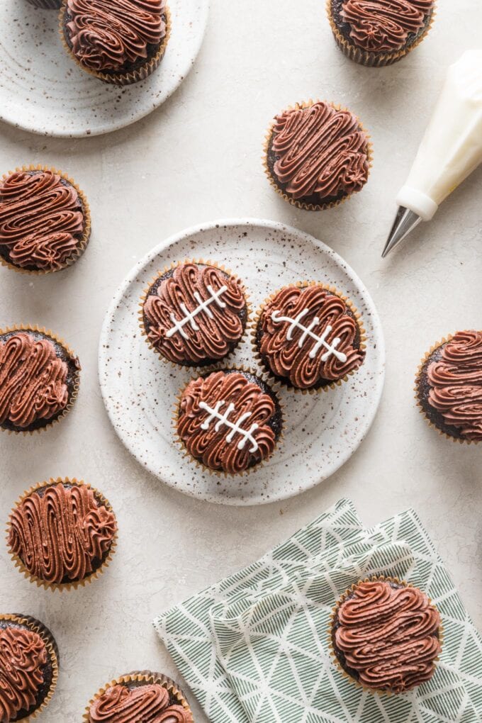 Partially decorated football cupcakes.