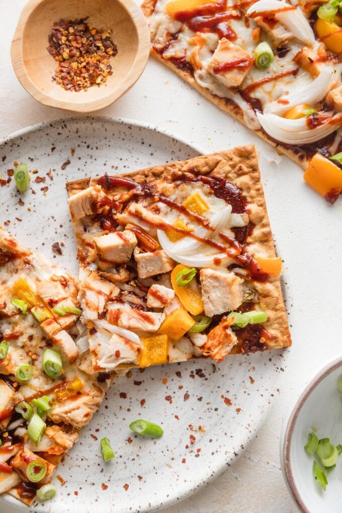 Lavash style flatbread topped with BBQ sauce, diced chicken, and veggies.