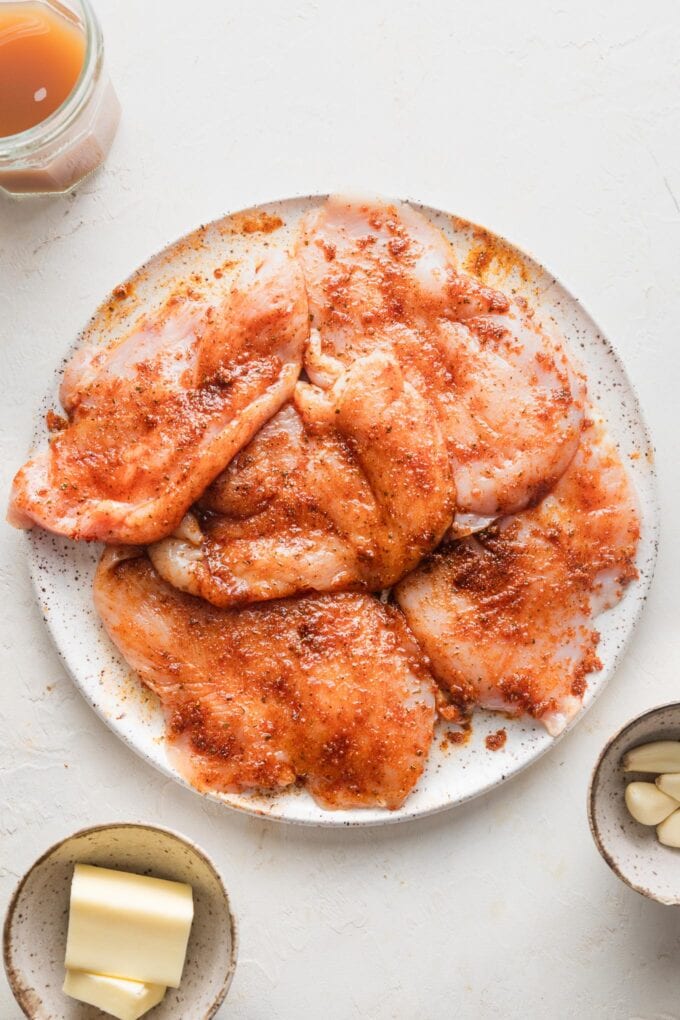 Chicken breasts seasoned with a Cajun spice rub and ready to cook.