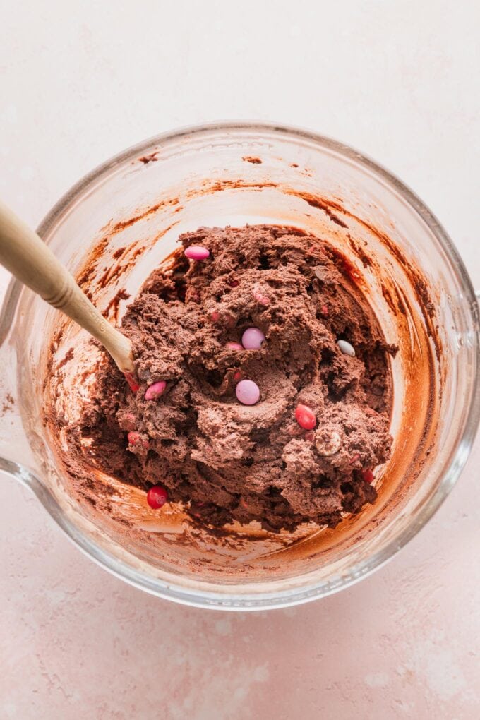 Close up of double chocolate cookie dough in a clear mixing bowl.