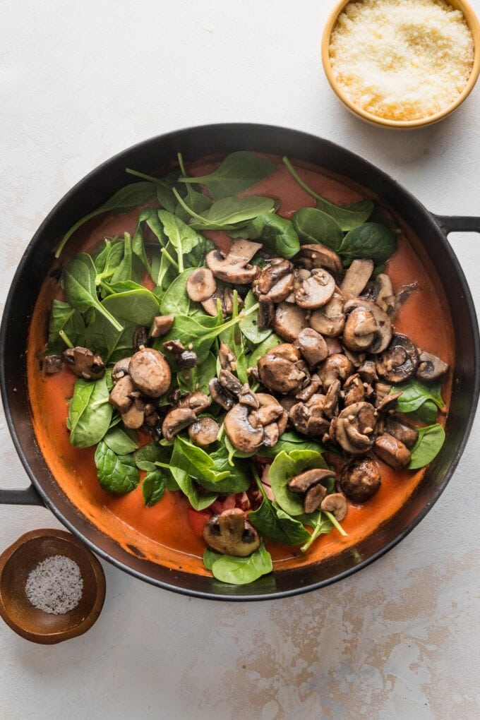 Mushrooms and baby spinach added to creamy tomato sauce.