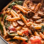 Close up of penne rosa in a deep cast iron skillet.