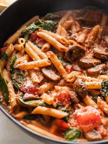 Close up of penne rosa in a deep cast iron skillet.