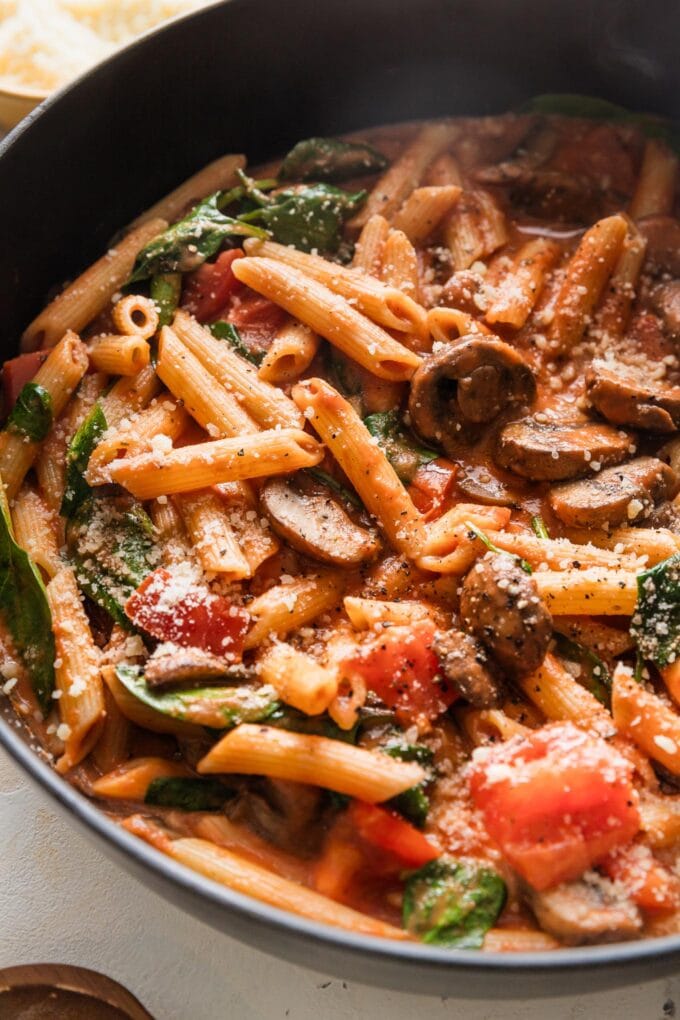 Close up of penne rosa in a deep cast iron skillet.