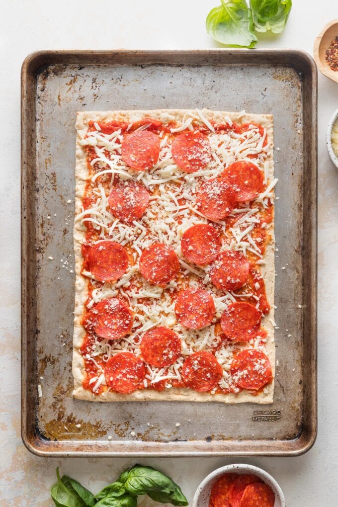 Unbaked pepperoni pizzas made on Lavash style flatbreads.