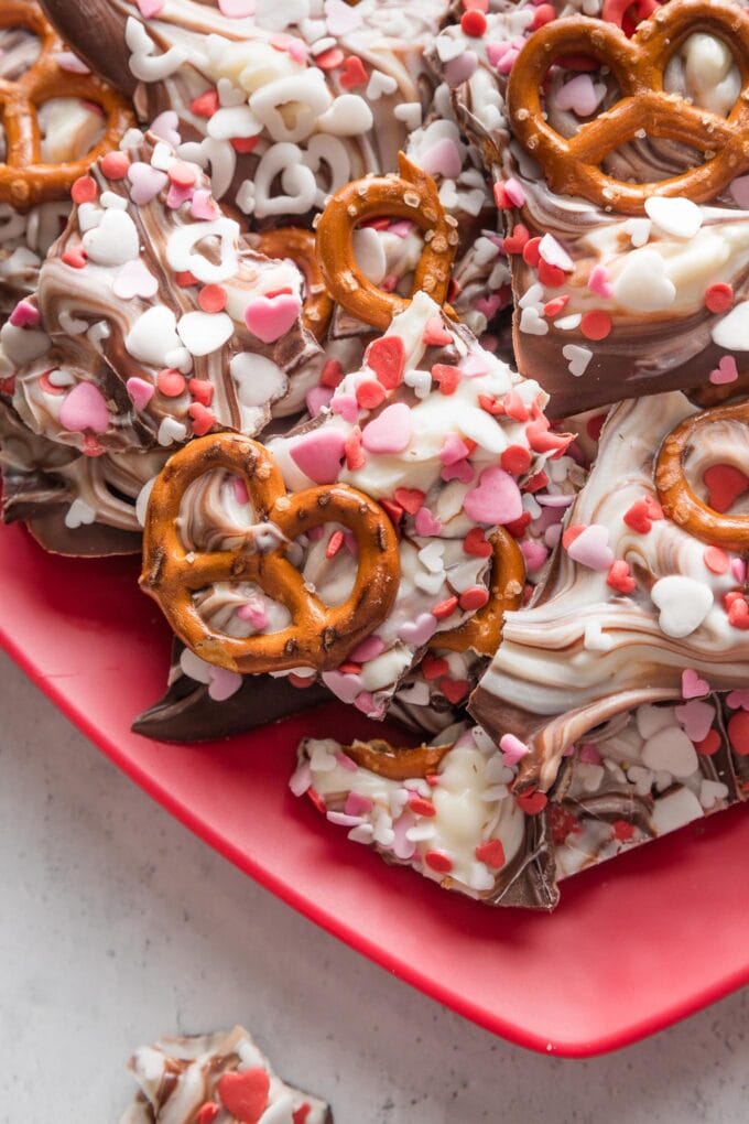 Close-up image of Valentine's bark with dark chocolate, white chocolate, pretzels, and sprinkles.
