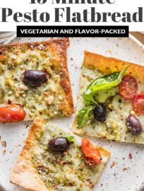 Crazy easy and packed with flavor, this Pesto Flatbread pizza has lots to love! We devour the fresh basil pesto, briny Kalamata olives, juicy tomatoes, and creamy mozzarella and Parmesan. And who doesn't enjoy a satisfying meal that takes just 5 minutes to toss together and 10 minutes to bake?