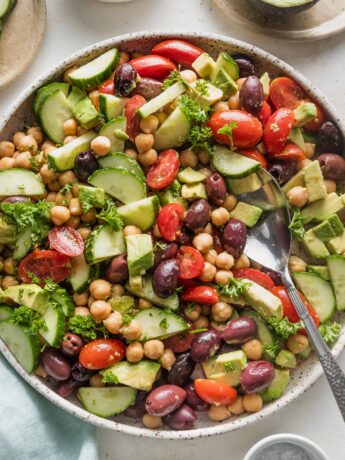 Overhead view of chickpea avocado salad in a large low bowl, ready to serve.